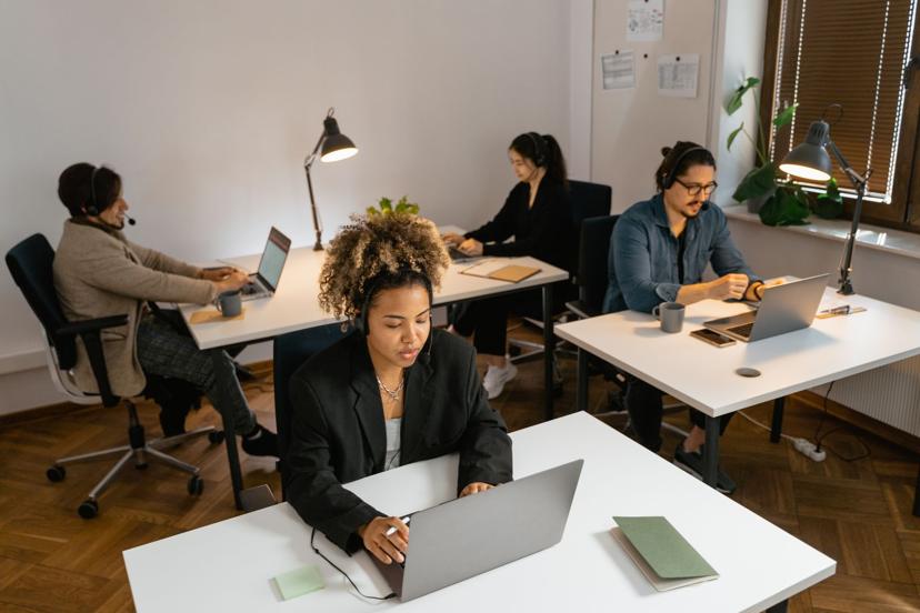A customer service team working at computers in a modern support office